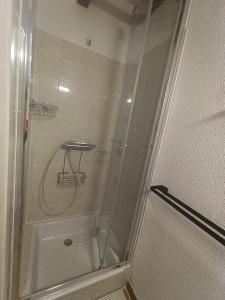a shower with a glass door in a bathroom at Maison à 800m de la plage classée 1 étoile in Capbreton