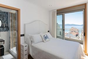 A bed or beds in a room at ÁTICO DE LUX SANXENXO