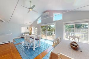 a kitchen and dining room with a table and chairs at Grand View Getaway in West Dennis