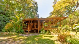 a wooden cabin in the middle of a garden at Casa Viva Eco Lodge in Puerto Viejo