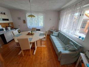 a living room with a table and a couch at Chalupa u Dionýza in Rejdová