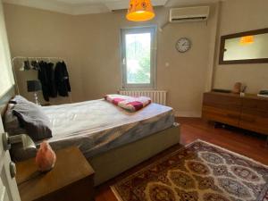 a bedroom with a large bed and a window at Private villa suitable for families with stunning sea views in Buyukcekmece