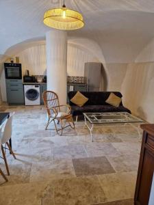 a living room with a couch and a chair at Logement privé avec terrasse in Chanonat