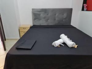 a bed with two rolled up towels on it at Relax an' Chill in Thessaloniki