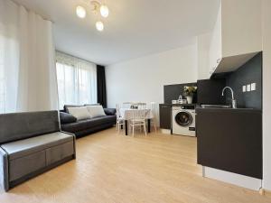 a living room with a couch and a table at Sweet home in Varna City