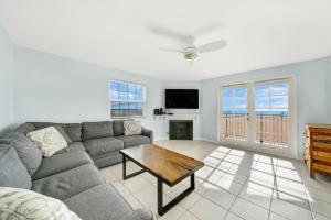 a living room with a couch and a table at 1404 W Oceanfront B in Newport Beach +14 photos