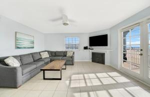 a living room with a couch and a tv at 1404 W Oceanfront B in Newport Beach