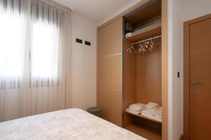 A bed or beds in a room at ÁTICO DE LUX SANXENXO