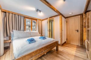 a bedroom with a bed with blue towels on it at Chalet Edelweiss in Saas-Almagell