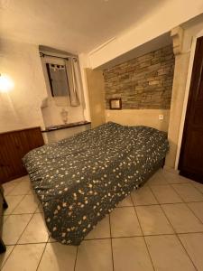 a bedroom with a bed with a blanket on it at Chez kay in Roquebrune-sur-Argens