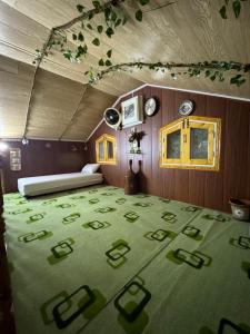 a room with a bed and a green carpet at Hidden Resort Abbottabad in Abbottabad