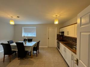 a kitchen with a table and chairs and a dining room at Holiday House in Galway