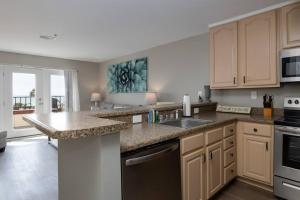 a kitchen with a sink and a counter top at Oceanfront Resort! at Ocean Delight! in North Topsail Beach