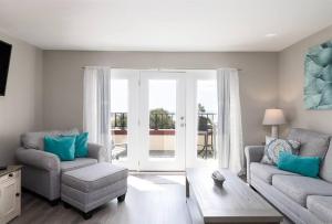 a living room with a couch and a chair at Oceanfront Resort! at Ocean Delight! in North Topsail Beach
