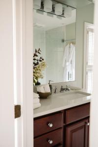 a bathroom with a sink and a mirror at The Federal Inn in Maumee +23 photos