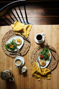 a wooden table with two plates of food and coffee at The Federal Inn in Maumee
