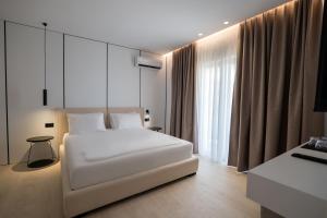 Postel nebo postele na pokoji v ubytování Arrei Hotel