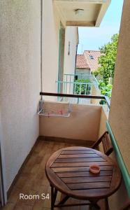 a room with a table and a balcony at Brela S1 S4-no parking in Brela +13 photos