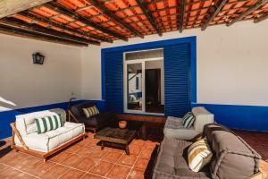 a living room with two couches and a table at Monte do Melo in Montemor-o-Novo