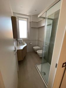 a bathroom with a toilet and a sink and a shower at Casa Regina in Civitanova Marche