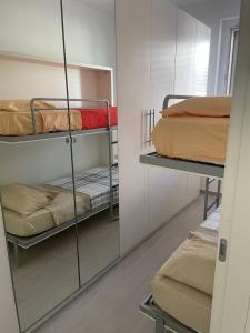 a room with two bunk beds and a mirror at Casa Regina in Civitanova Marche