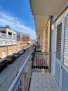 a balcony with a view of a street with parked cars at Casa Regina in Civitanova Marche