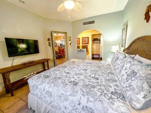 a bedroom with a large bed and a flat screen tv at Sandy Beach Princesa D107 Ocean Front Resort in Puerto Peñasco +55 photos