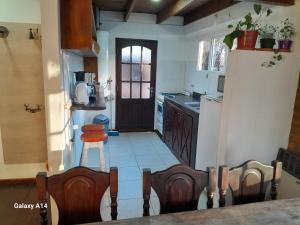 a kitchen with a table and a counter top at Casa de Mimbres in El Calafate +11 photos