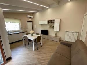 a living room with a table and a couch at Connie's Home in Agerola
