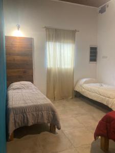 a small room with two beds and a window at Casa finca La catalina I in Maco +16 photos