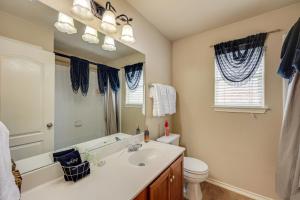 a bathroom with a sink and a toilet and a mirror at San Antonio Home - Outdoor Oasis and Greenbelt Views in San Antonio +33 photos