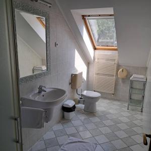 a bathroom with a sink and a toilet at Kígyósi Csárda & Panzió in Fülöpszállás +36 photos