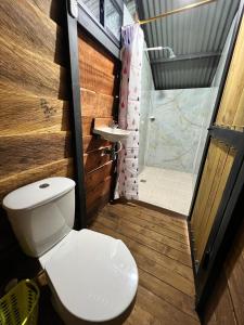 a small bathroom with a toilet and a shower at Mirador del Padre in Gómez Plata