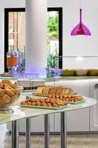 a tray of bread and pastries on a table at Prize by Radisson, Hamburg City in Hamburg