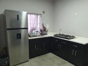 a kitchen with a stainless steel refrigerator and a sink at Habitacion Matrimonial in Monterrey