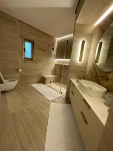 a bathroom with a sink and a toilet and a shower at Sunny Coastal villa, luxury gateway! in Caesarea