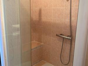 a shower stall with a glass door with a shower at Superbe T3 avec loggias fermées, garage, et wifi à Balaruc-les-Bains, classé 3 étoiles - FR-1-553-216 in Balaruc-les-Bains +7 photos