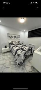a bedroom with a large bed with a marble floor at Le Rogers in Pointe-Calumet