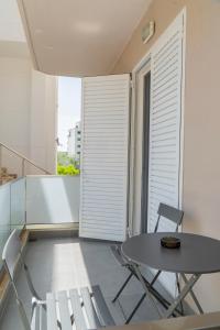 a small balcony with a table and chairs at Koks’ Guesthouse in Himare