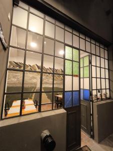 a room with a view of a mountain through a window at La Félicité Hostel in Salta +18 photos