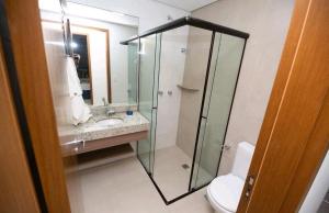 a bathroom with a shower and a sink and a toilet at Alta Vista Thermas Resort in Caldas Novas