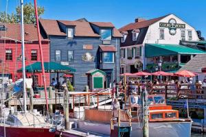 a boat docked at a marina with a restaurant at Middletown Modern Townhouse in Middletown