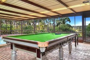 a pool table on a patio with a view at Luxury Vineyard Retreat in McLaren Vale