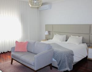 a bedroom with a bed and a chair at The Oak´S Wolf-Country House in Fafe +46 photos