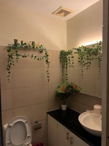 a bathroom with a toilet and a sink at SMDC Wind Residences Tower 4 Taal view in Tagaytay