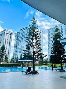 a person sitting in a chair next to a pool at SMDC Wind Residences Tower 4 Taal view in Tagaytay