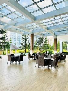 a dining room with tables and chairs in a building at SMDC Wind Residences Tower 4 Taal view in Tagaytay