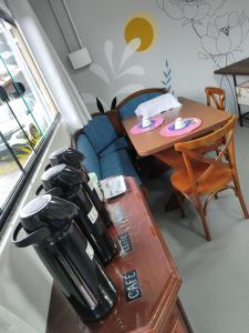 a living room with a table and a couch and a table and a table at Maga hospedagem in Penha