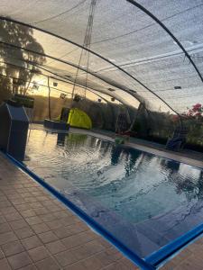 a swimming pool with a canopy over it at فيلا الهنا in Tangier
