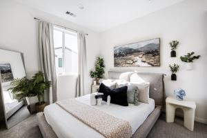 a white bedroom with a bed and a window at Brand New Stunning 4BR Townhome in Lemon Grove +28 photos